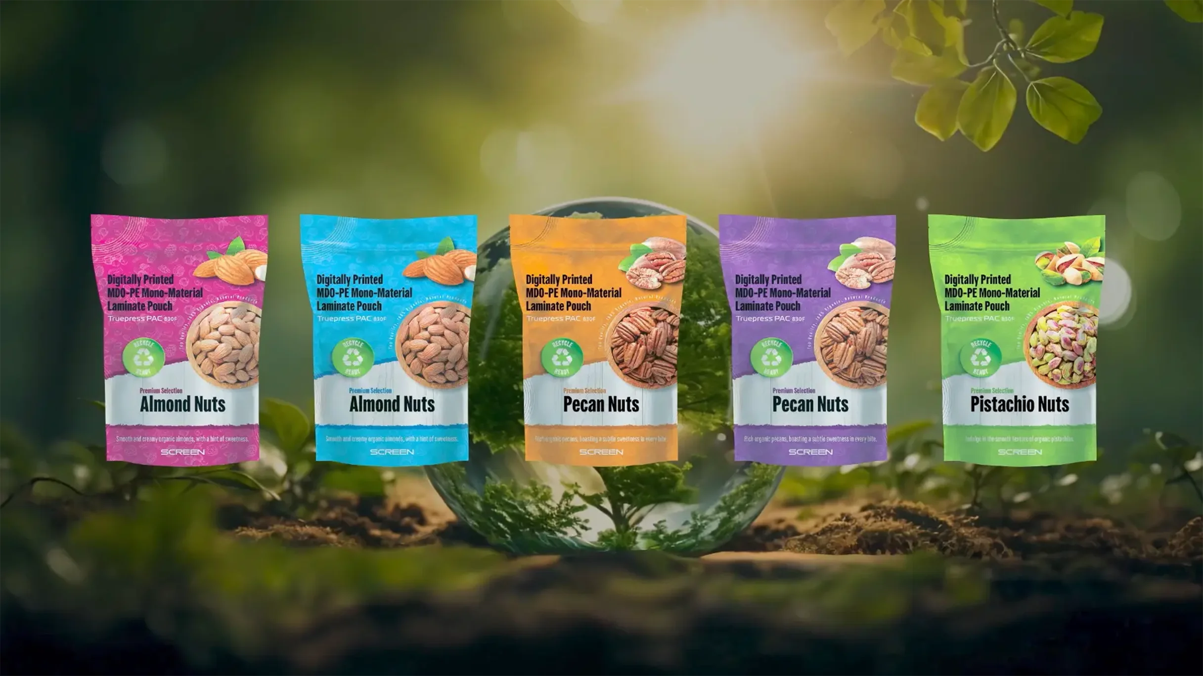 Five digitally printed, MDO-PE mono-material laminate pouches for various nuts, displayed in an outdoor, nature-focused setting with a prominent recycling icon, representing the environmentally friendly printing capabilities of the Truepress PAC 830F.
